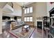 Spacious living room boasts hardwood floors, soaring ceilings, and a cozy fireplace at 7130 Rocking Horse Ln, Cumming, GA 30040