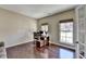 Bright office space with hardwood floors, large windows, and a modern desk at 7130 Rocking Horse Ln, Cumming, GA 30040