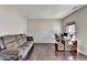 Comfortable office space with a plush sofa, wooden desk and hardwood floors at 7130 Rocking Horse Ln, Cumming, GA 30040