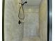 Walk in shower with tile surround and black trim at 7130 Rocking Horse Ln, Cumming, GA 30040