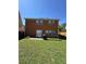 Expansive backyard featuring a two-story home with direct access through glass doors at 1668 Scenic Pines Dr, Lawrenceville, GA 30044