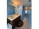 Vanity with double sinks in a blue-painted primary bathroom with a view to shower area at 1668 Scenic Pines Dr, Lawrenceville, GA 30044