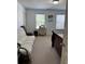 Bedroom featuring carpeted floors, two windows, and an additional sofa for added functionality and relaxation at 1668 Scenic Pines Dr, Lawrenceville, GA 30044