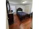 Bedroom features a dark wood bedframe and matching vanity set with ample natural light from a bright window at 1668 Scenic Pines Dr, Lawrenceville, GA 30044