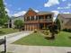 Charming two-story home with a balcony, brick accents, and well-maintained landscaping at 1668 Scenic Pines Dr, Lawrenceville, GA 30044