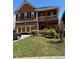 Charming two-story home featuring a brick facade and covered porch, complemented by a well-maintained lawn at 1668 Scenic Pines Dr, Lawrenceville, GA 30044