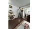 Elegant hallway leading to a living area, with dark wood flooring, decorative mirror, and tasteful decor at 1668 Scenic Pines Dr, Lawrenceville, GA 30044