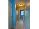 View down a hallway with a tiled floor, a door and a shower room at 1668 Scenic Pines Dr, Lawrenceville, GA 30044