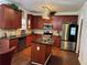 Modern kitchen featuring a stainless steel refrigerator, wooden cabinetry, and granite countertops at 1668 Scenic Pines Dr, Lawrenceville, GA 30044