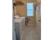 Functional laundry room with a washer, dryer, wire shelving, and vinyl flooring for easy maintenance at 1668 Scenic Pines Dr, Lawrenceville, GA 30044