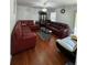A living room with hardwood floors, a glass table and two leather sofas at 1668 Scenic Pines Dr, Lawrenceville, GA 30044