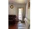 Bright living room featuring modern couches, hardwood floors, and natural light from the door to the patio at 1668 Scenic Pines Dr, Lawrenceville, GA 30044