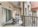Charming balcony featuring stately columns, comfortable seating, and serene views of the complex at 200 River Vista Dr # 713, Atlanta, GA 30339