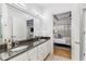 Bathroom features a double sink vanity with granite counters and ensuite access at 200 River Vista Dr # 713, Atlanta, GA 30339