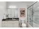 Elegant bathroom featuring a granite countertop, a framed mirror, and a glass-enclosed shower at 200 River Vista Dr # 713, Atlanta, GA 30339