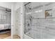 Bright bathroom features a shower-tub with a glass enclosure and a shampoo niche at 200 River Vista Dr # 713, Atlanta, GA 30339