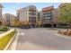 Exterior shot of a condo community with colorful fall foliage and brick paver driveway at 200 River Vista Dr # 713, Atlanta, GA 30339