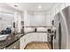 Modern kitchen with granite countertops and stainless steel appliances view to the living room at 200 River Vista Dr # 713, Atlanta, GA 30339