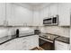 Modern kitchen features white cabinetry, stainless steel appliances and granite countertops at 200 River Vista Dr # 713, Atlanta, GA 30339