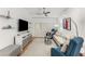 Bright living room with contemporary furnishings, sleek entertainment center, and modern ceiling fan at 200 River Vista Dr # 713, Atlanta, GA 30339