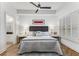 Bright main bedroom features a ceiling fan, bedside tables, and an en suite bathroom at 200 River Vista Dr # 713, Atlanta, GA 30339