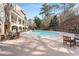 Large swimming pool surrounded by lounge chairs and lush greenery, perfect for relaxation at 200 River Vista Dr # 713, Atlanta, GA 30339