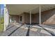 Under deck patio with stone pavers, gravel, brick pillars and siding, and sliding glass door to basement at 208 Indian Hills Trail, Marietta, GA 30068