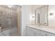 Elegant bathroom featuring a vanity with decorative lighting and tiled shower/tub at 208 Indian Hills Trail, Marietta, GA 30068