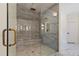 Modern bathroom boasting a glass enclosed shower with marble style tile and bronze fixtures at 208 Indian Hills Trail, Marietta, GA 30068