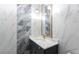 Modern bathroom with marble tile, sleek vanity, and stylish lighting fixtures at 208 Indian Hills Trail, Marietta, GA 30068