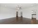 This bedroom boasts hardwood floors, a modern ceiling fan, and access to the en suite bath and closet at 208 Indian Hills Trail, Marietta, GA 30068