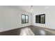 Bright bedroom featuring hardwood floors, white walls, and black-framed windows, providing natural light at 208 Indian Hills Trail, Marietta, GA 30068