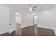 Bedroom features hardwood floors, a modern ceiling fan, and access to the rest of the home at 208 Indian Hills Trail, Marietta, GA 30068