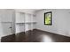 Walk-in closet with white built-in shelves, hanging rods, and dark wood floors at 208 Indian Hills Trail, Marietta, GA 30068