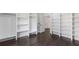 Spacious walk-in closet featuring custom shelving and dark wood floors at 208 Indian Hills Trail, Marietta, GA 30068