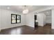 Bright dining room with wood floors, modern lighting, and a large window at 208 Indian Hills Trail, Marietta, GA 30068
