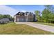 Spacious home featuring a long driveway and a large lawn at 208 Indian Hills Trail, Marietta, GA 30068