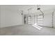 Spacious two-car garage featuring tall ceilings, and white doors with glass panels allowing natural light at 208 Indian Hills Trail, Marietta, GA 30068