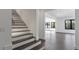 Hallway with staircase, leading to a spacious living area with large windows at 208 Indian Hills Trail, Marietta, GA 30068