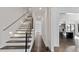 Hallway featuring staircase, hardwood floors, and modern lighting at 208 Indian Hills Trail, Marietta, GA 30068