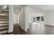 Hallway featuring hardwood floors and a staircase leading to an open-concept living space with large windows at 208 Indian Hills Trail, Marietta, GA 30068