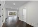Hallway with hardwood flooring, neutral walls, and entryways to the bathroom and living space at 208 Indian Hills Trail, Marietta, GA 30068