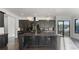Open kitchen with black cabinets, island, and marble countertops at 208 Indian Hills Trail, Marietta, GA 30068