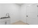 Modern laundry room with a white cabinet and stainless-steel sink at 208 Indian Hills Trail, Marietta, GA 30068