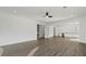 Bright, open living area with modern ceiling fan and hardwood floors leading to open-concept kitchen at 208 Indian Hills Trail, Marietta, GA 30068