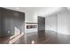 Spacious living room with hardwood floors, elegant fireplace, and stylish wall paneling at 208 Indian Hills Trail, Marietta, GA 30068
