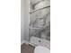 Custom shower featuring gray marble-look tile, mosaic floor, and rain shower fixture at 208 Indian Hills Trail, Marietta, GA 30068