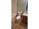 Tiled bathroom with a granite countertop sink and vanity, toilet, and white tub at 8628 Thomas Rd, Riverdale, GA 30274