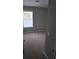 Carpeted bedroom featuring a window with blinds, neutral paint, and a light switch at 8628 Thomas Rd, Riverdale, GA 30274