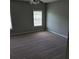 Carpeted bedroom featuring two windows with blinds, neutral paint, and a ceiling fan at 8628 Thomas Rd, Riverdale, GA 30274